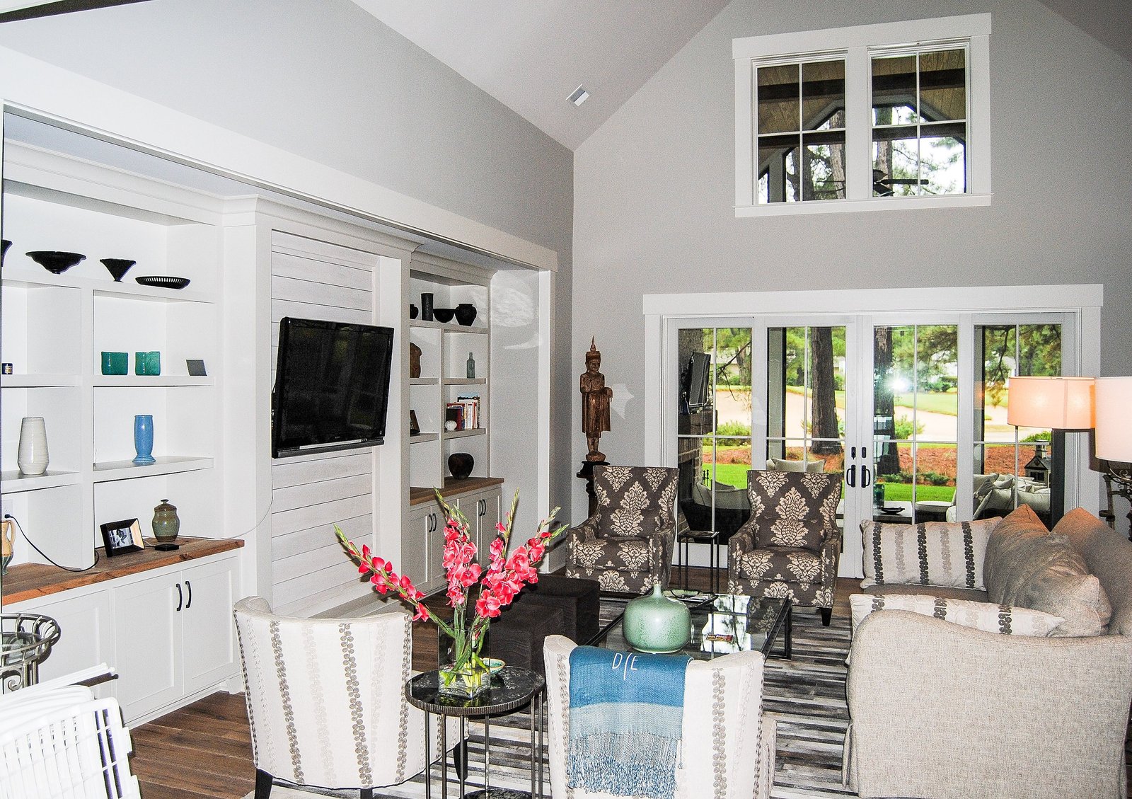 Vaulted living room with custom built-ins and layered, comfortable seating