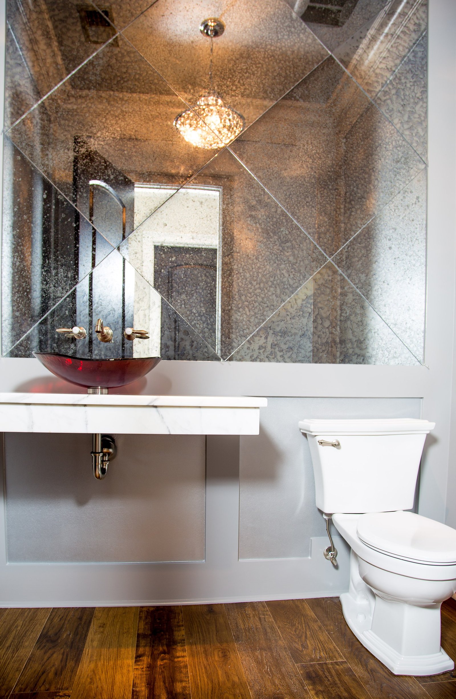 Powder room clad in travertine with a vessel sink